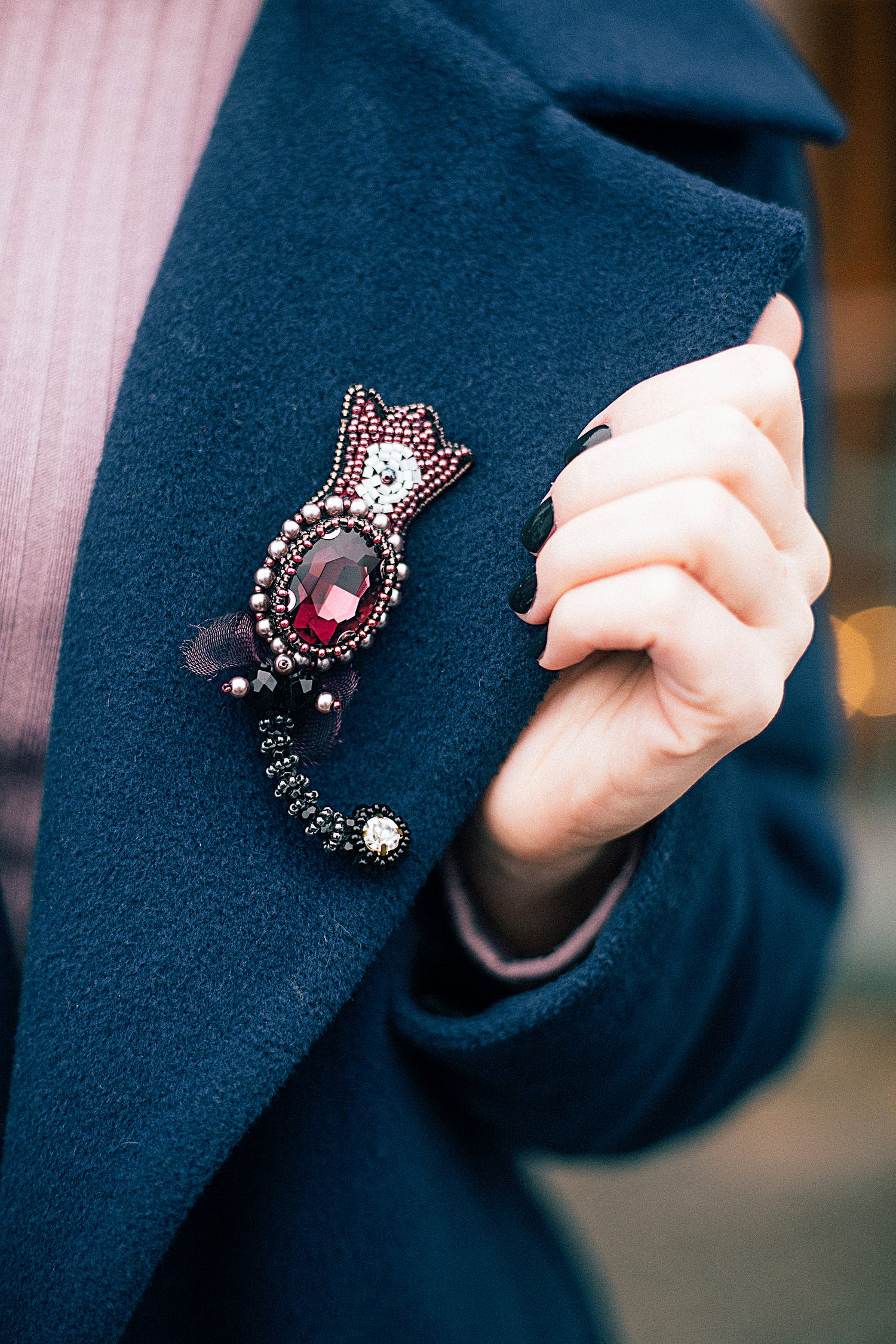 Wearing a brooch with a blue coat