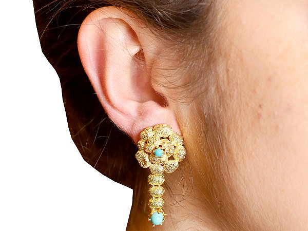 wearing turquoise drop earrings