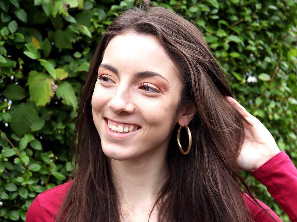 gold hoop earrings being worn 