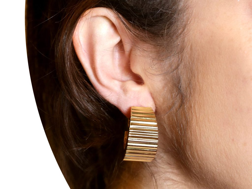 chunky gold hoop earrings being worn 