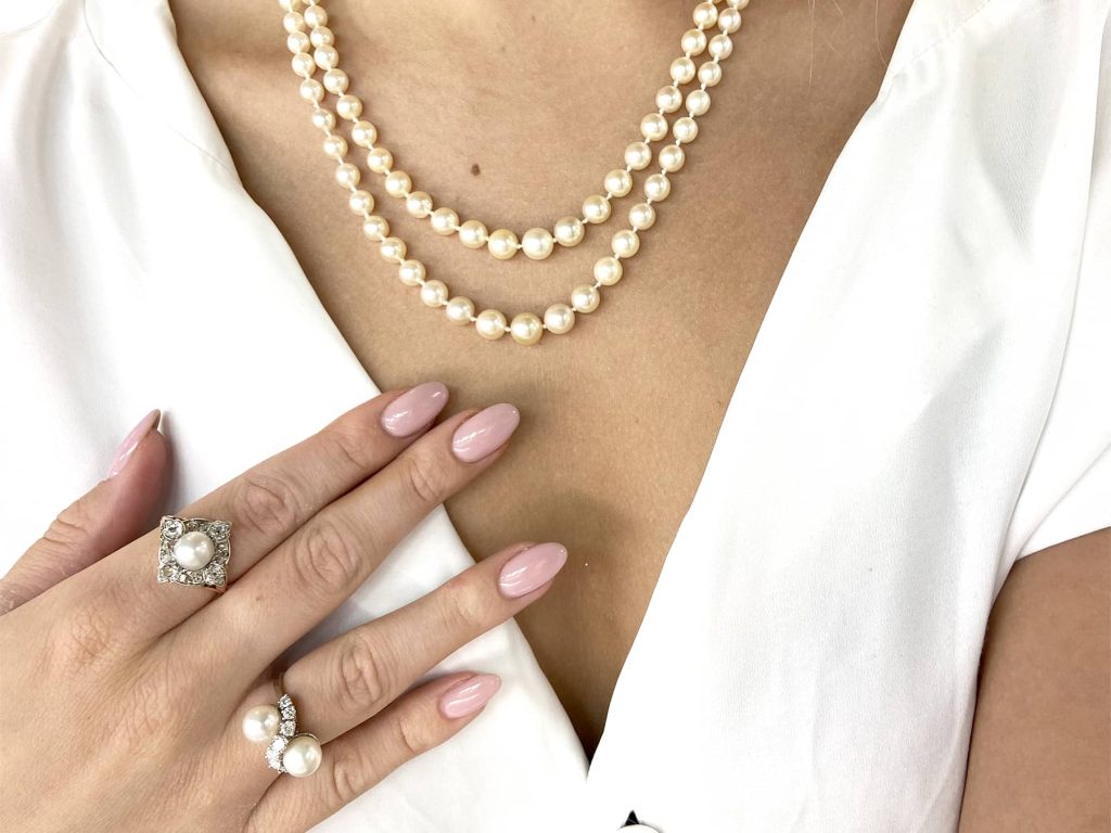 wearing pearl necklace and rings 