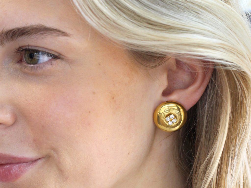 wearing gold and diamond earrings 