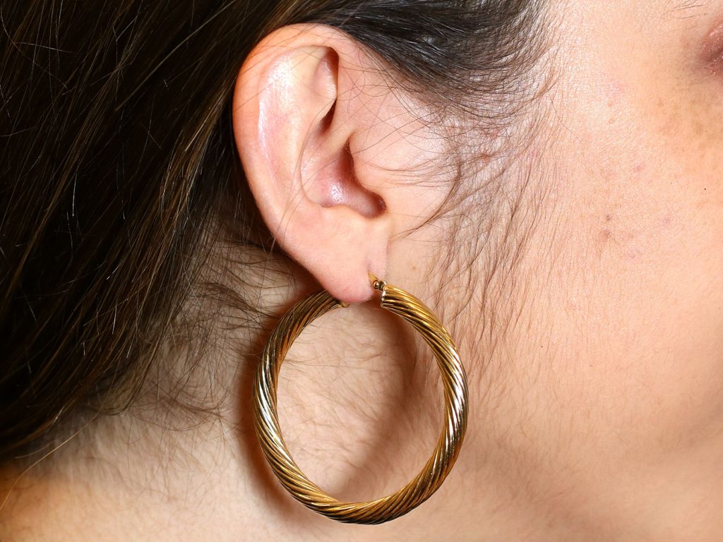 wearing gold hoop earrings 