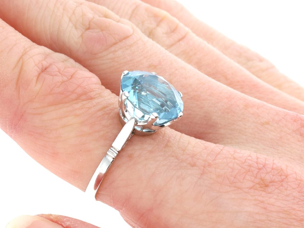 thin band aquamarine ring on hand