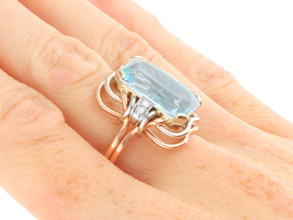 rose gold and aquamarine ring on hand 