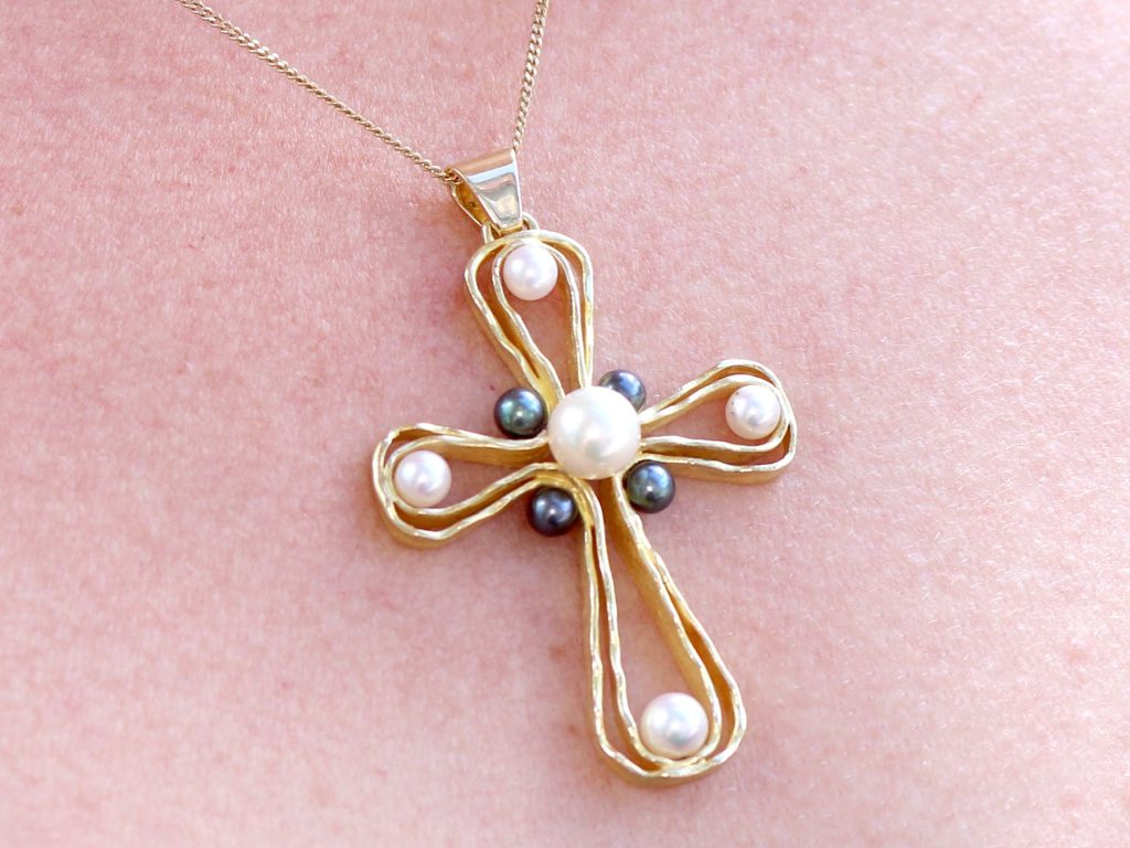 wearing gold and pearl 970s cross pendant 