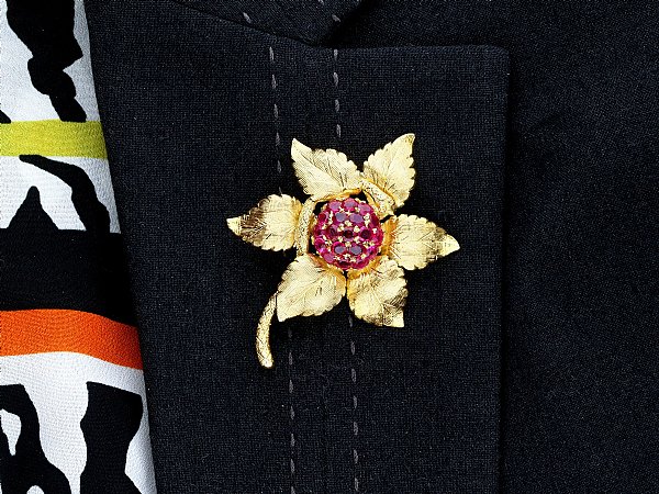 ruby floral brooch on collar 