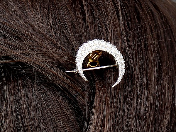 crescent brooch in hair close up