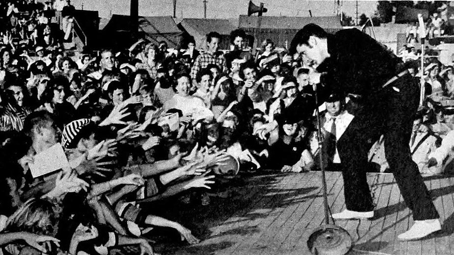 Elvis performing live at the Mississippi-Alabama Fairgrounds in Tupelo, September 26, 1956. via Public Domain