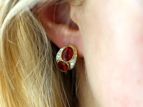 fire opal and yellow gold earrings in ear 